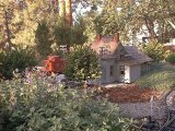 The stations comes into view through the trees...